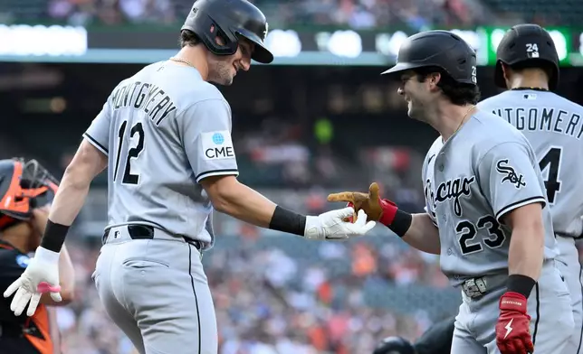 Chicago White Sox's Colson Montgomery (12) celebrates his two-run home run with Andrew Benintendi (23) during the third inning of a baseball game against the Baltimore Orioles, Tuesday, June 30, 2026, in Baltimore. (AP Photo/Nick Wass)