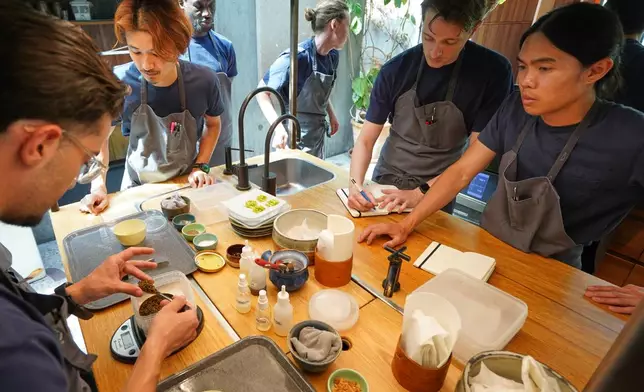 Chefs busily practice making dishes in fine-dining restaurant Noma's kitchen ahead of its new season in Copenhagen, Denmark Tuesday, July 28, 2026. (AP Photo/James Brooks)