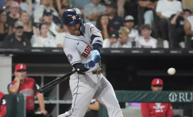Houston Astros' Christian Walker hits a three-run double against the Chicago White Sox during the sixth inning of a baseball game Friday, July 24, 2026, in Chicago. (AP Photo/David Banks)