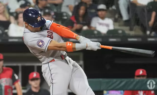 Houston Astros' Cam Smith hits a two-run homer against the Chicago White Sox during the sixth inning of a baseball game Friday, July 24, 2026, in Chicago. (AP Photo/David Banks)