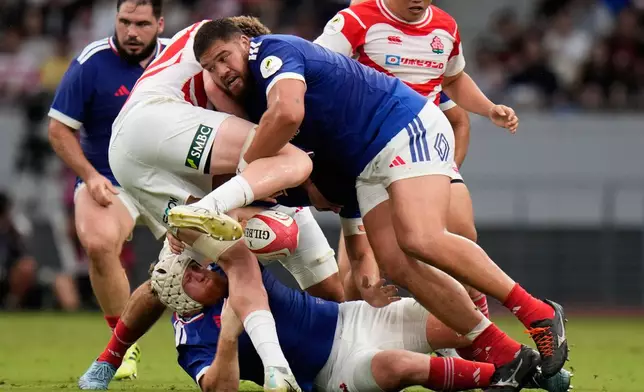 France's Emmanuel Meafou, second from right, is tackled during a Nations Championship rugby match between Japan and France in Tokyo, Saturday, July 18, 2026. (AP Photo/Shuji Kajiyama)