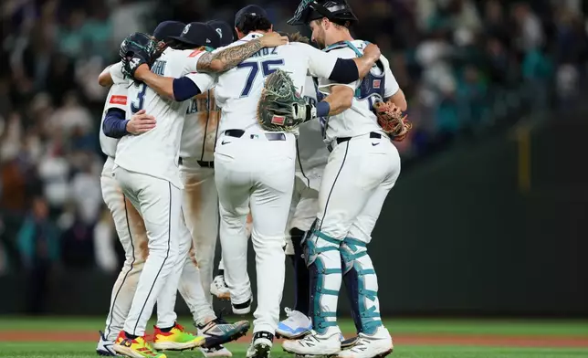 The Seattle Mariners celebrate after defeating the Los Angeles Angels in a baseball game Tuesday, June 30, 2026, in Seattle. (AP Photo/Kevin Ng)