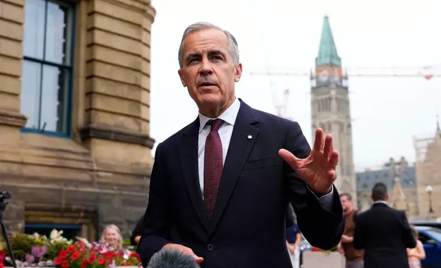 Canada Prime Minister Mark Carney makes a statement outside the Office of the Prime Minister and Privy Council in Ottawa, on Tuesday, July 21, 2026. (Justin Tang/The Canadian Press via AP)
