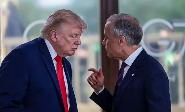 FILE - President Donald Trump speaks with Canadian Prime Minister Mark Carney, right, at a working lunch with leaders of G7 and the Middle East in Evian-les-Bains, France, Tuesday, June 16, 2026. (Evelyn Hockstein/Pool Photo via AP,File)