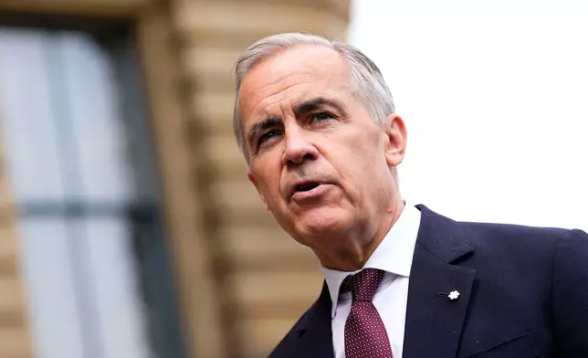 Prime Minister Mark Carney makes a statement outside the Office of the Prime Minister and Privy Council in Ottawa, on Tuesday, July 21, 2026. (Justin Tang/The Canadian Press via AP)