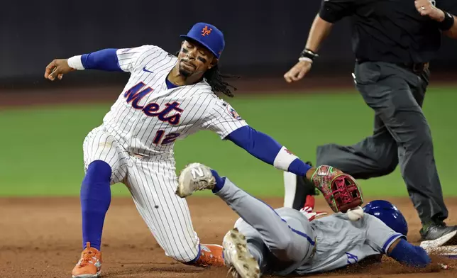 Kansas City Royals' Tyler Tolbert safely steals second base as New York Mets shortstop Francisco Lindor (12) drops the ball during the fifth inning of a baseball game Tuesday, July 7, 2026, in New York. (AP Photo/Adam Hunger)
