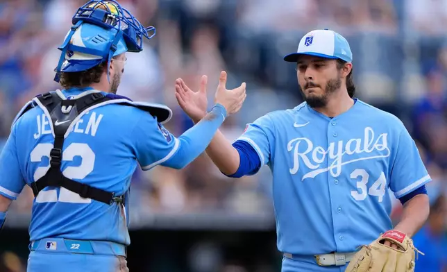Kansas City Royals pitcher Eli Morgan (34) celebrates with catcher Carter Jensen (22) after their baseball game against the San Diego Padres, Saturday, July 18, 2026, in Kansas City, Mo. (AP Photo/Charlie Riedel)