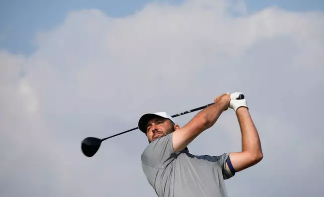 Scottie Scheffler of the United States tees off on the 11th hole during the third day of the British Open Golf championships at Royal Birkdale golf club, in Southport, England, Saturday, July 18, 2026. (AP Photo/David Goldman)