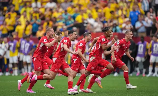 Switzerland players celebrate after defeating Colombia in a penalty shootout in the World Cup round of 16 soccer match between Switzerland and Colombia in Vancouver, British Columbia, Tuesday, July 7, 2026. (Darryl Dyck/The Canadian Press via AP)
