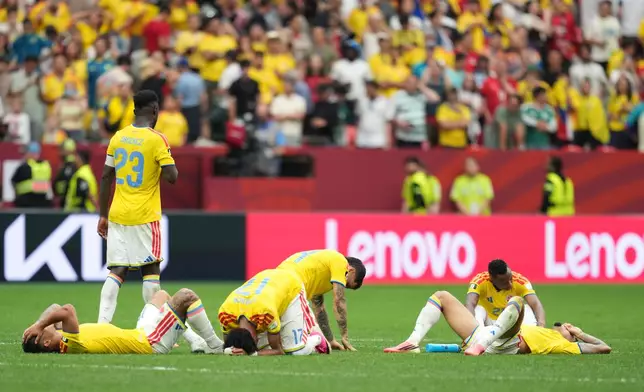 Colombian players lie dejected after losing penalty shootout during the World Cup round of 16 soccer match between Switzerland and Colombia in Vancouver, British Columbia, Tuesday, July 7, 2026. (AP Photo/Abbie Parr)