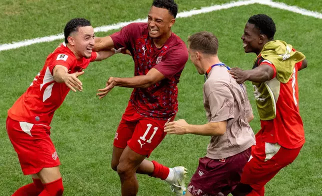 Switzerland's Ruben Vargas, left, celebrates with teammates after making the winning kick in a penalty shootout in the World Cup round of 16 soccer match between Switzerland and Colombia in Vancouver, British Columbia, Tuesday, July 7, 2026. (Timothy Matwey/The Canadian Press via AP)