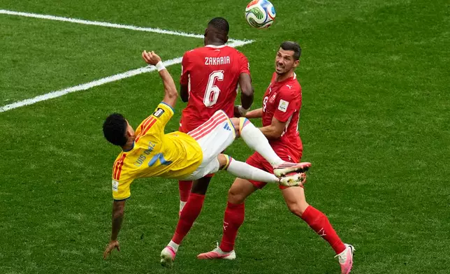 Colombia's Luis Diaz (7) attempts a bicycle kick against Switzerland's Denis Zakaria (6) and Remo Freuler (8) during the World Cup round of 16 soccer match in Vancouver, British Columbia, Tuesday, July 7, 2026. (AP Photo/Gregory Bull)