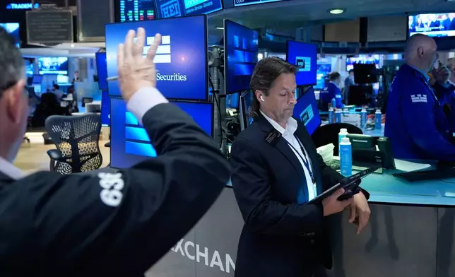 Patrick McKeon works on the floor at the New York Stock Exchange in New York, Monday, July 6, 2026. (AP Photo/Seth Wenig)