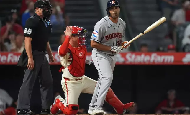 Houston Astros' LaMonte Wade, Jr. (31) reacts to walking to force in the go-ahead run against the Los Angeles Angels during the ninth inning of a baseball game Monday, July 27, 2026, in Anaheim, Calif. (AP Photo/Scott Strazzante)