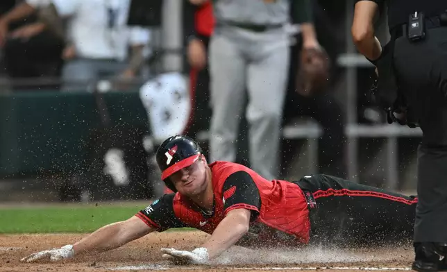 Chicago White Sox's Kyle Teel slides safely into home plate while scoring on a Sam Antonacci single during the fifth inning of a baseball game against The Athletics in Chicago, Friday, July 10, 2026. (AP Photo/Paul Beaty)