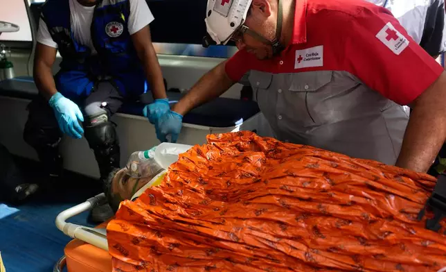 Rescue workers carry Alberto Gil after he was pulled from the rubble eight days after he was trapped by twin earthquakes that struck Catia La Mar, Venezuela. in Catia La Mar, Venezuela, Thursday, July 2, 2026. (AP Photo/Fernando Vergara)