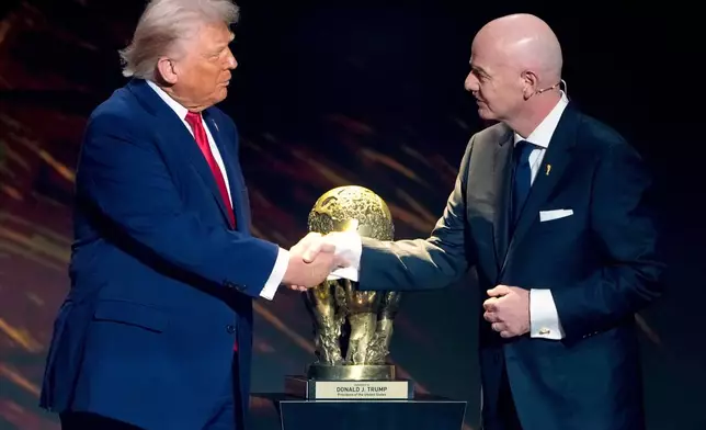 FILE - FIFA President Gianni Infantino, right, awards President Donald Trump with the FIFA Peace Prize during the draw for the 2026 soccer World Cup at the Kennedy Center in Washington, Dec. 5, 2025. (AP Photo/Chris Carlson, File)