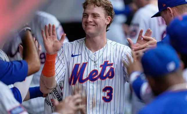 New York Mets' Carson Benge celebrates in the dugout after scoring on a Francisco Alvarez single during the fifth inning of a baseball game against the Kansas City Royals, Thursday, July 9, 2026, in New York. (AP Photo/Seth Wenig)
