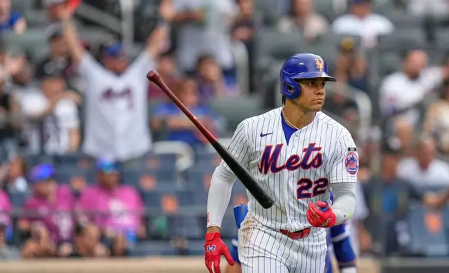New York Mets' Juan Soto throws his bat after hitting a solo home run during the seventh inning of a baseball game against the Kansas City Royals, Thursday, July 9, 2026, in New York. (AP Photo/Seth Wenig)
