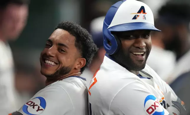 Houston Astros' Jeremy Pena, left, and Yordan Alvarez, right, celebrate after their back-to-back home runs off Miami Marlins starting pitcher Janson Junk during the second inning of a baseball game, Monday, July 20, 2026, in Houston. (AP Photo/Karen Warren)