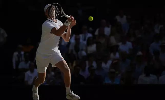 Jannik Sinner of Italy plays a return to Alexander Zverev of Germany men's singles final at Wimbledon Tennis Championships in London, Sunday, July 12, 2026. (AP Photo/Kin Cheung)