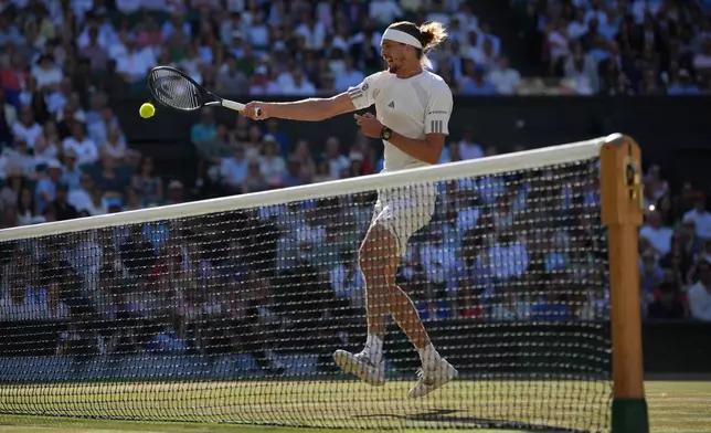 Alexander Zverev of Germany hits a return to Jannik Sinner of Italy during the men's singles final at Wimbledon Tennis Championships in London, Sunday, July 12, 2026. (AP Photo/Kin Cheung)