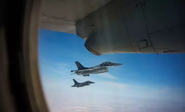 FILE - Romanian Air Force F-16 military fighter jets escort a C-27J Spartan aircraft during a NATO Air Policing exercise above eastern Romania, on March 6, 2024. (AP Photo/Andreea Alexandru, File)