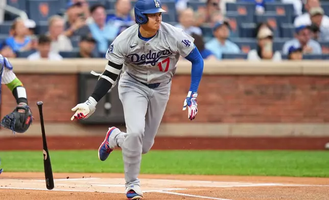 Los Angeles Dodgers' Shohei Ohtani runs to first base for a single during the first inning of a baseball game against the New York Mets Friday, July 24, 2026, in New York. (AP Photo/Frank Franklin II)