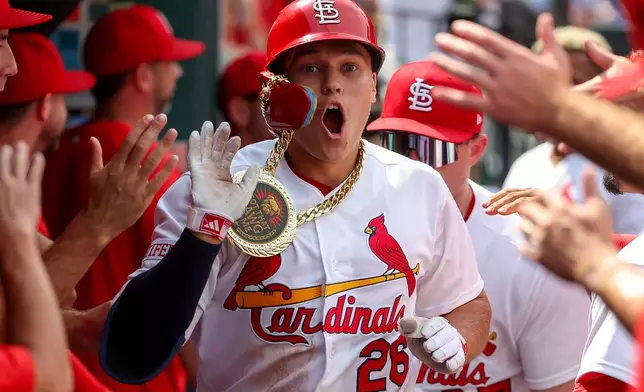 St. Louis Cardinals' JJ Wetherholt is congratulated by teammates after hitting a solo home run during the seventh inning of a baseball game against the Chicago Cubs, Thursday, July 30, 2026, in St. Louis. (AP Photo/Scott Kane)