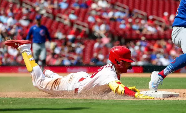 St. Louis Cardinals' Bryan Torres is out as he slides into first base during the sixth inning of a baseball game against the Chicago Cubs, Thursday, July 30, 2026, in St. Louis. (AP Photo/Scott Kane)