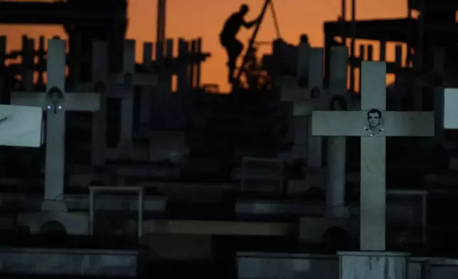 Crosses stand on the graves of Greek and Greek Cypriot soldiers killed in the 1974 Turkish invasion in Cyprus at the Tymvos Macedonitissas military cemetery in the divided capital of Nicosia, Cyprus, Sunday, July 19, 2026. (AP Photo/Petros Karadjias)