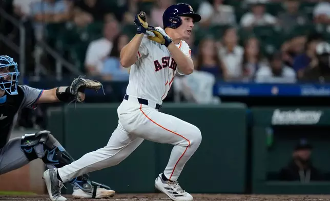Houston Astros' Lucas Spence hits an RBI double during the second inning of a baseball game against the Miami Marlins, Tuesday, July 21, 2026, in Houston. (AP Photo/Kevin M. Cox)