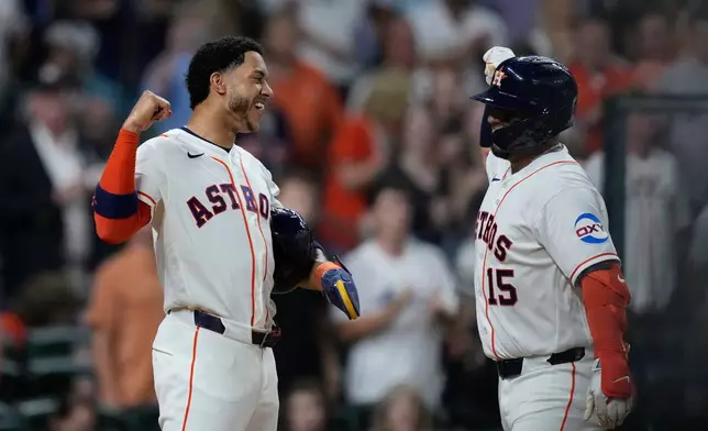 Houston Astros' Isaac Paredes, right, celebrates with Jeremy Peña after hitting a three-run home run during the fifth inning of a baseball game against the Miami Marlins, Tuesday, July 21, 2026, in Houston. (AP Photo/Kevin M. Cox)