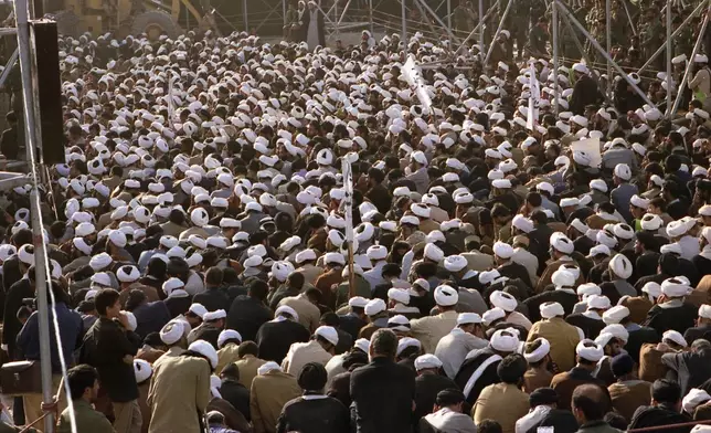 FILE - Mourners crowd around the grave of the late Ayatollah Khomeini at the cemetery in Beheshte e Zahra, some 70 kms from Tehran, Iran, June 11, 1989. (AP Photo/Heribert Proepper, File)