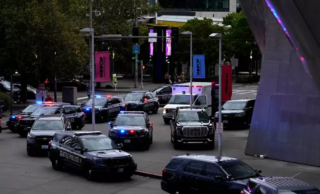 Seattle police respond to a shooting at Seattle Center during the Bite of Seattle food festival Sunday, July 26, 2026, in Seattle, Wash. (AP Photo/Lindsey Wasson)