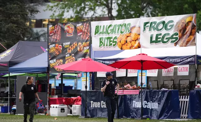 Police respond to a shooting at Seattle Center during the Bite of Seattle food festival Sunday, July 26, 2026, in Seattle, Wash. (AP Photo/Lindsey Wasson)