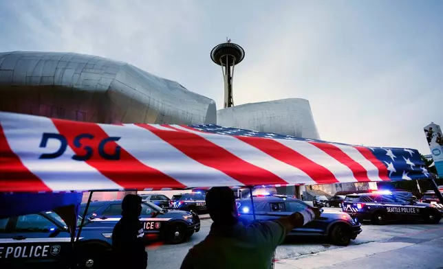 Police respond to a shooting at Seattle Center during the Bite of Seattle food festival Sunday, July 26, 2026, in Seattle, Wash. (AP Photo/Lindsey Wasson)