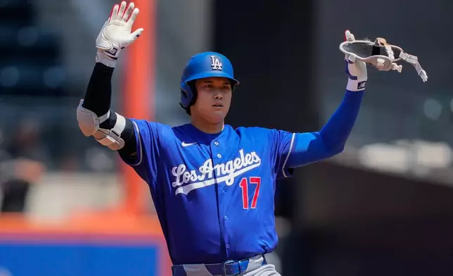 Los Angeles Dodgers designated hitter Shohei Ohtani gestures after hitting a double during the first inning of a baseball game against the New York Mets, Sunday, July 26, 2026, in New York. (AP Photo/Yuki Iwamura)