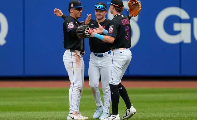 New York Mets right fielder Carson Benge, right, center fielder A.J. Ewing, center, and left fielder Tyrone Taylor, left, celebrate after winning a baseball game against the Los Angeles Dodgers, Sunday, July 26, 2026, in New York. (AP Photo/Yuki Iwamura)