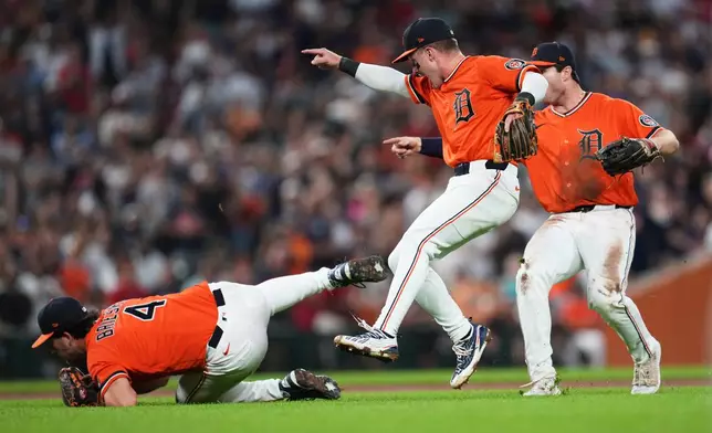 Detroit Tigers pitcher Beau Brieske (4) catches a Philadelphia Phillies' Rafael Marchán pop up as Kevin McGonigle, center, and Colt Keith, right, react to the final out during the ninth inning Friday, July 10, 2026, in Detroit. (AP Photo/Paul Sancya)