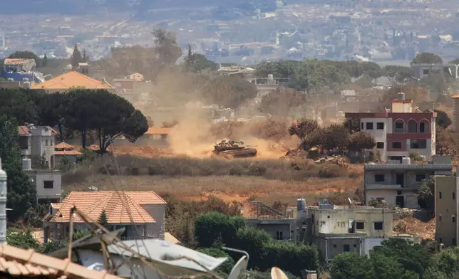 An Israeli tank drives through Zawtar al-Sharqiyah village, occupied by Israeli forces, as seen from the southern village of Zawtar al-Gharbieh, Lebanon, Monday, July 27, 2026. (AP Photo/Mustafa Jamalddine)