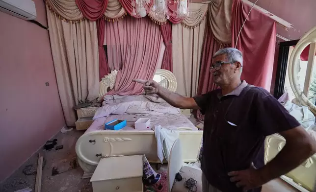 Mohammed Sobeih gestures inside his home, destroyed during the Israeli military operation, after returning to it in Zawtar al-Gharbieh, Lebanon, Tuesday, July 28, 2026. (AP Photo/Hassan Ammar)