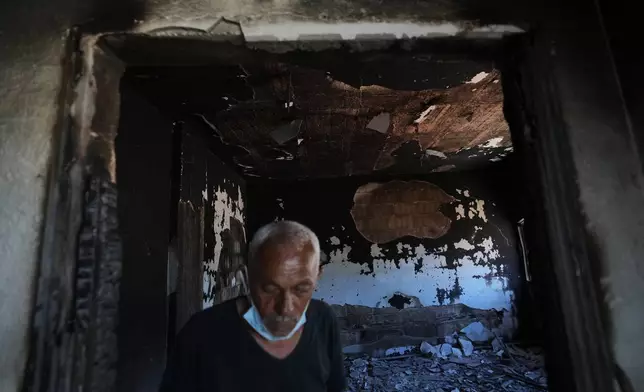 A resident inspects his home, which was burned during an Israeli military operation, in Zawtar al-Gharbieh, Lebanon, Tuesday, July 28, 2026. (AP Photo/Hassan Ammar)