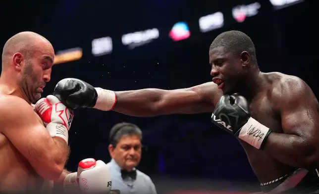 Germany's Peter Kadiru, right, lands a punch on Russia's Murat Gassiev during a WBA Heavyweight world title boxing match as part of the IBA Pro 19 event in Moscow, Russia, Saturday, July. 11, 2026. (AP Photo/Pavel Bednyakov)