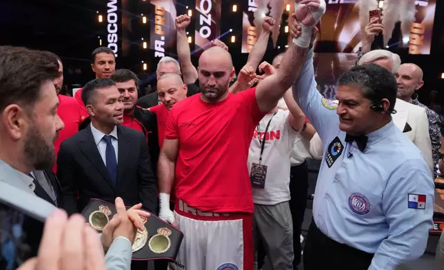 Russia's Murat Gassiev, centre, celebrates after defeating Germany's Peter Kadiru during a WBA Heavyweight world title boxing match as part of the IBA Pro 19 event in Moscow, Russia, Saturday, July. 11, 2026. (AP Photo/Pavel Bednyakov)