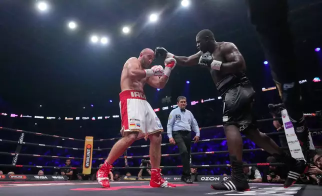 Germany's Peter Kadiru, right, lands a punch on Russia's Murat Gassiev during a WBA Heavyweight world title boxing match as part of the IBA Pro 19 event in Moscow, Russia, Saturday, July. 11, 2026. (AP Photo/Pavel Bednyakov)