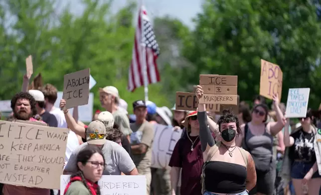 Protesters gather near the scene of a shooting involving U.S. Immigration and Customs Enforcement, Monday, July 13, 2026 in Biddeford, Maine. (AP Photo/Robert F. Bukaty)