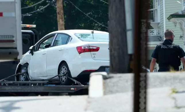 A vehicle with a damaged window is transported away from the scene of a shooting involving U.S. Immigration and Customs Enforcement, Monday, July 13, 2026 in Biddeford, Maine. (AP Photo/Robert F. Bukaty)