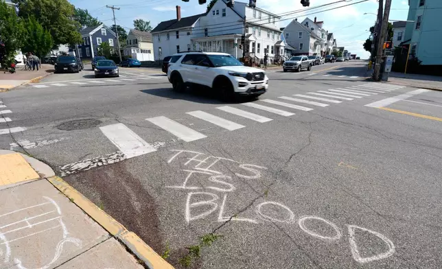 Blood is seen on the pavement near the scene of a shooting involving U.S. Immigration and Customs Enforcement, Monday, July 13, 2026 in Biddeford, Maine. (AP Photo/Robert F. Bukaty)