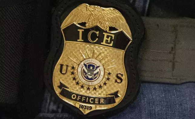 FILE - A federal agent wears an Immigration and Customs Enforcement badge in New York, June 10, 2025. (AP Photo/Yuki Iwamura, File)